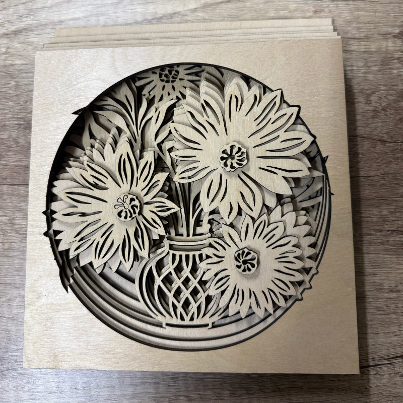 Laser-cut wooden card with floral design on a wooden surface