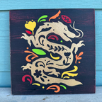 Decorative wall art with a stylized dragon design on a dark background