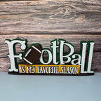 Wooden sign with 'Football is my favorite season' text and football graphic on a wooden background