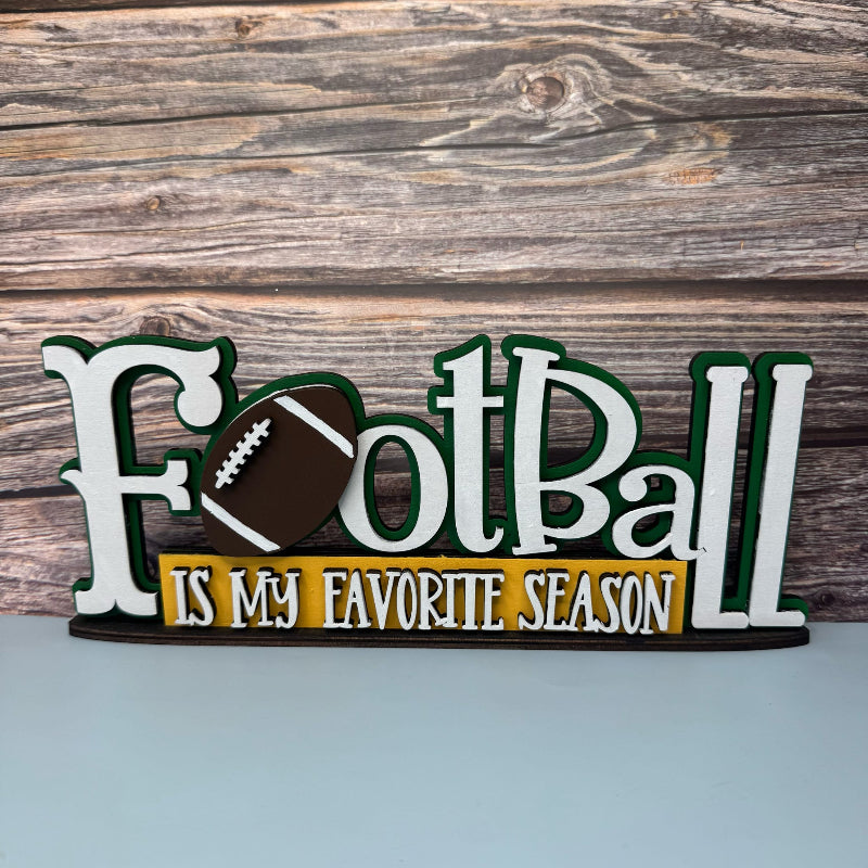 Wooden sign with 'Football is my favorite season' text and football graphic on a wooden background
