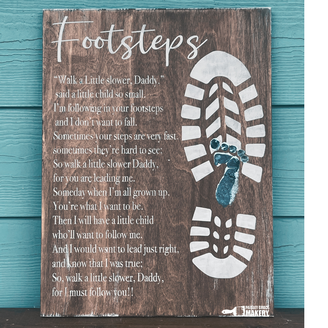 A wooden plaque with a poem titled 'Footsteps' and a footprint design underneath the title. Father's Day Design