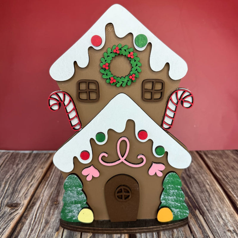 Decorative gingerbread house on a wooden surface with a red background