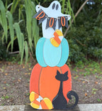 Halloween-themed decorative sign with a ghost, pumpkin, and black cat on a metal stand.