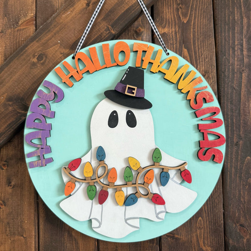 Decorative sign with ghost, witch hat, and Christmas lights on a wooden background
