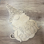 Wooden cutout of a gnome with 'Hello Fall' text on a wooden surface