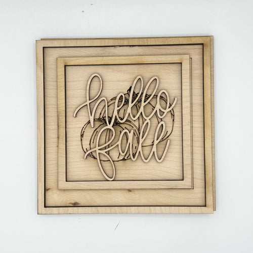 Unpainted laser-cut wood pieces for the Hello Fall Framed Sign, before paint