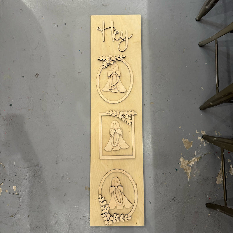 Wooden plaque with engraved designs and text on a gray surface