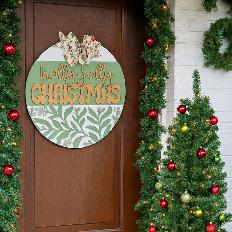 Decorative Christmas scene with a door sign, tree, and presents.