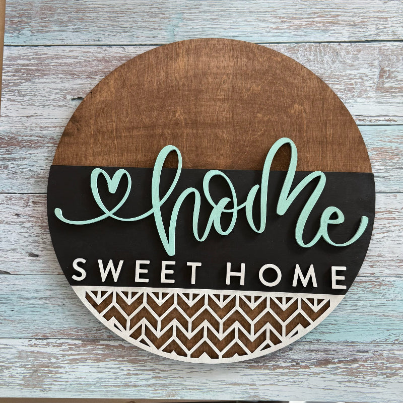 Wooden sign with 'home sweet home' text on a wooden surface