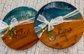 Two engraved epoxy lazy susans wrapped with bows as gifts