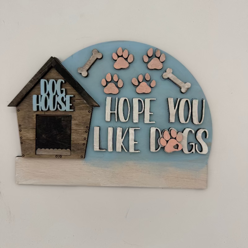 Decorative sign with a dog house, bones, and paw prints on a light blue background.