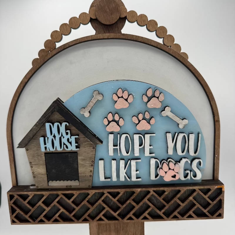 Decorative sign with a dog house, bones, and paw prints on a white background