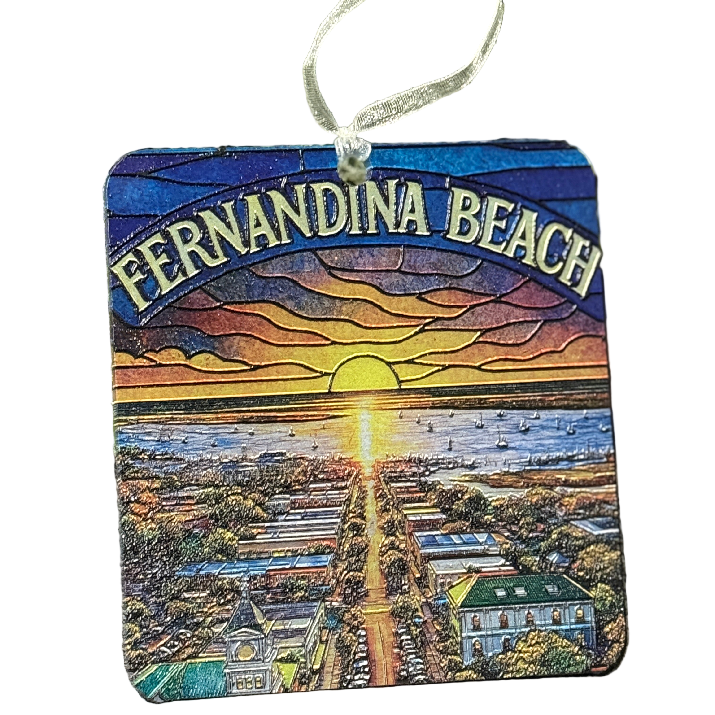 Decorative ornament with 'Fernandina Beach' text and sunset scene on sand and trees background