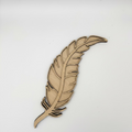 Wooden feather decoration on a light gray background