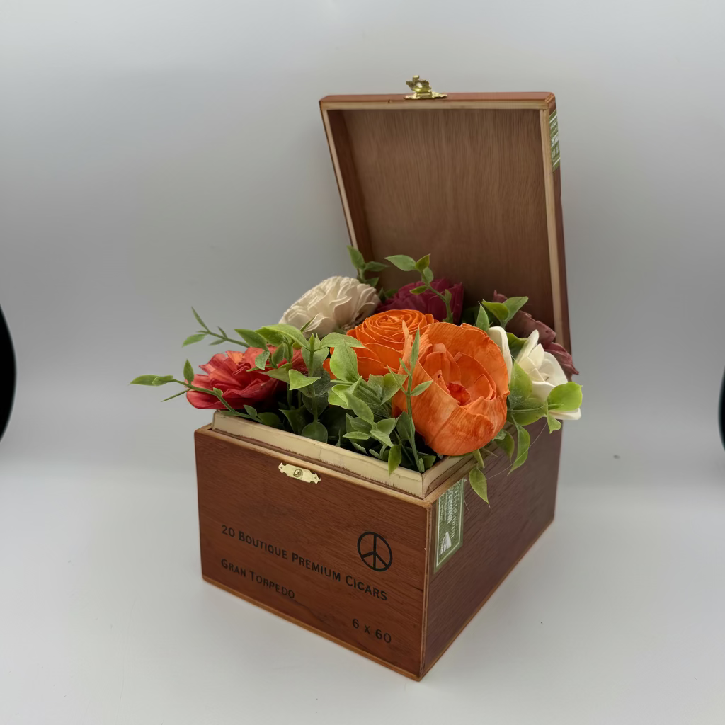 Wooden cigar box with flowers on a white background