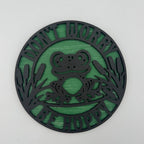 Decorative circular sign with a frog design and text 'Don't Worry Be Happy' on a white background
