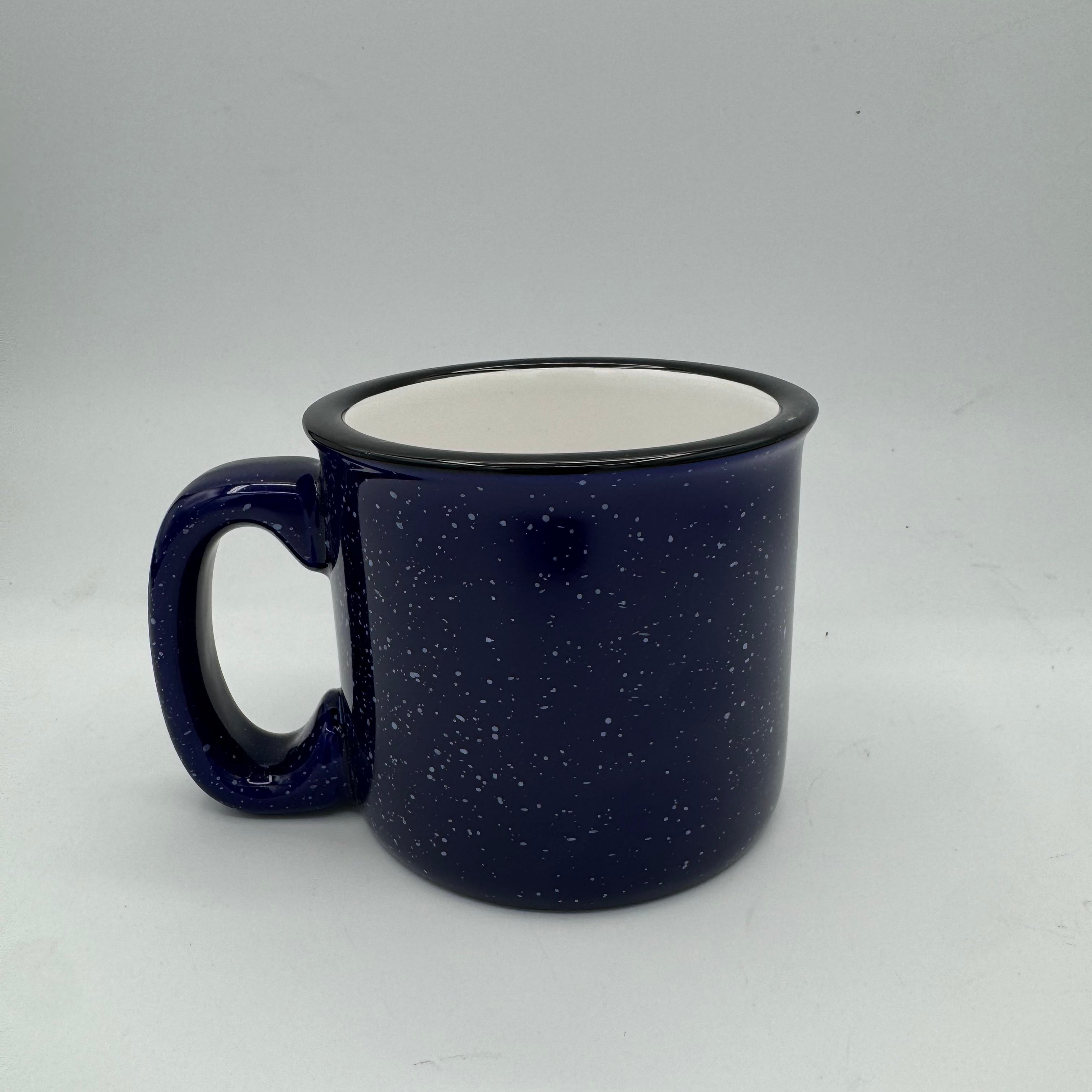 Blue speckled mug with a white interior on a light gray background