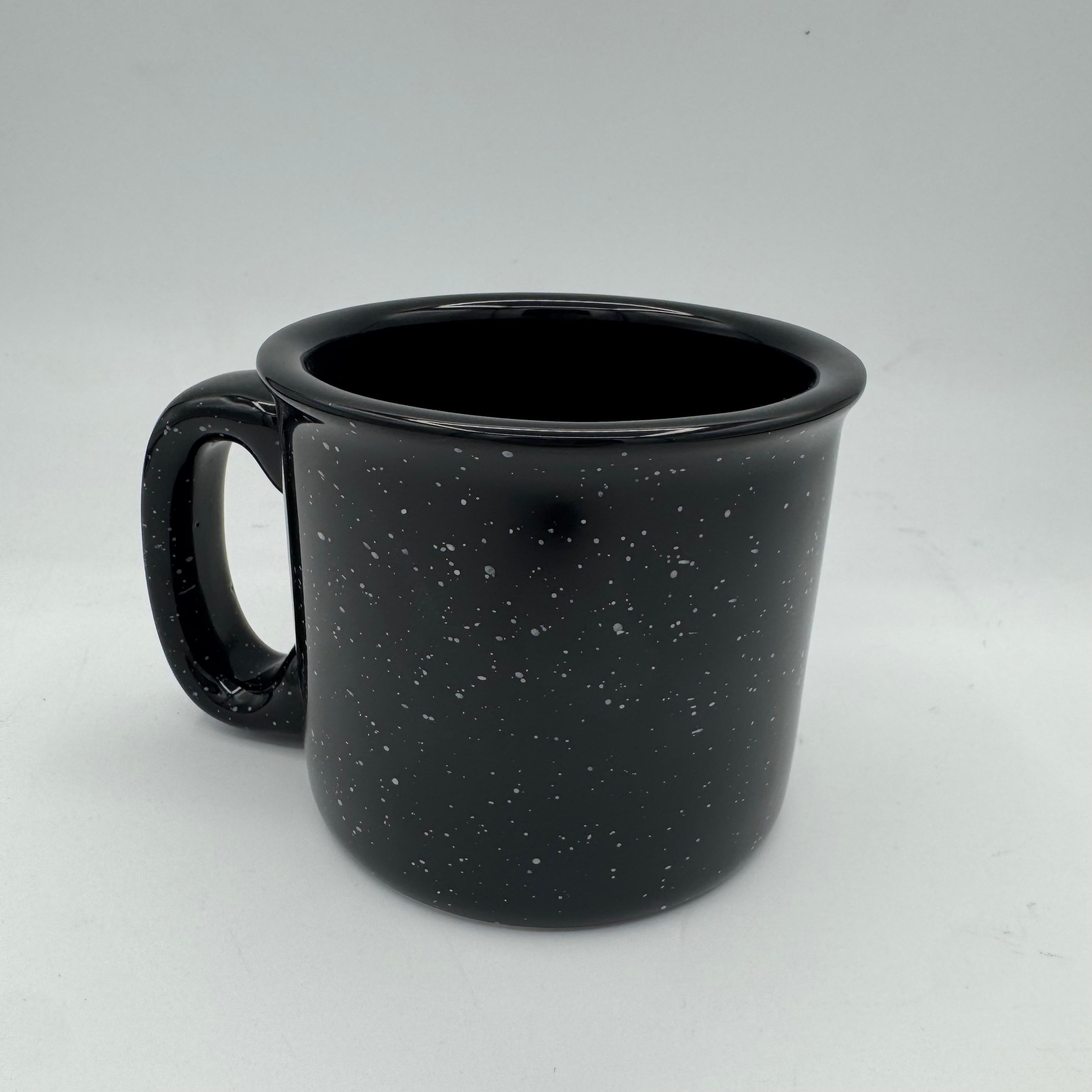 Black speckled mug on a white background