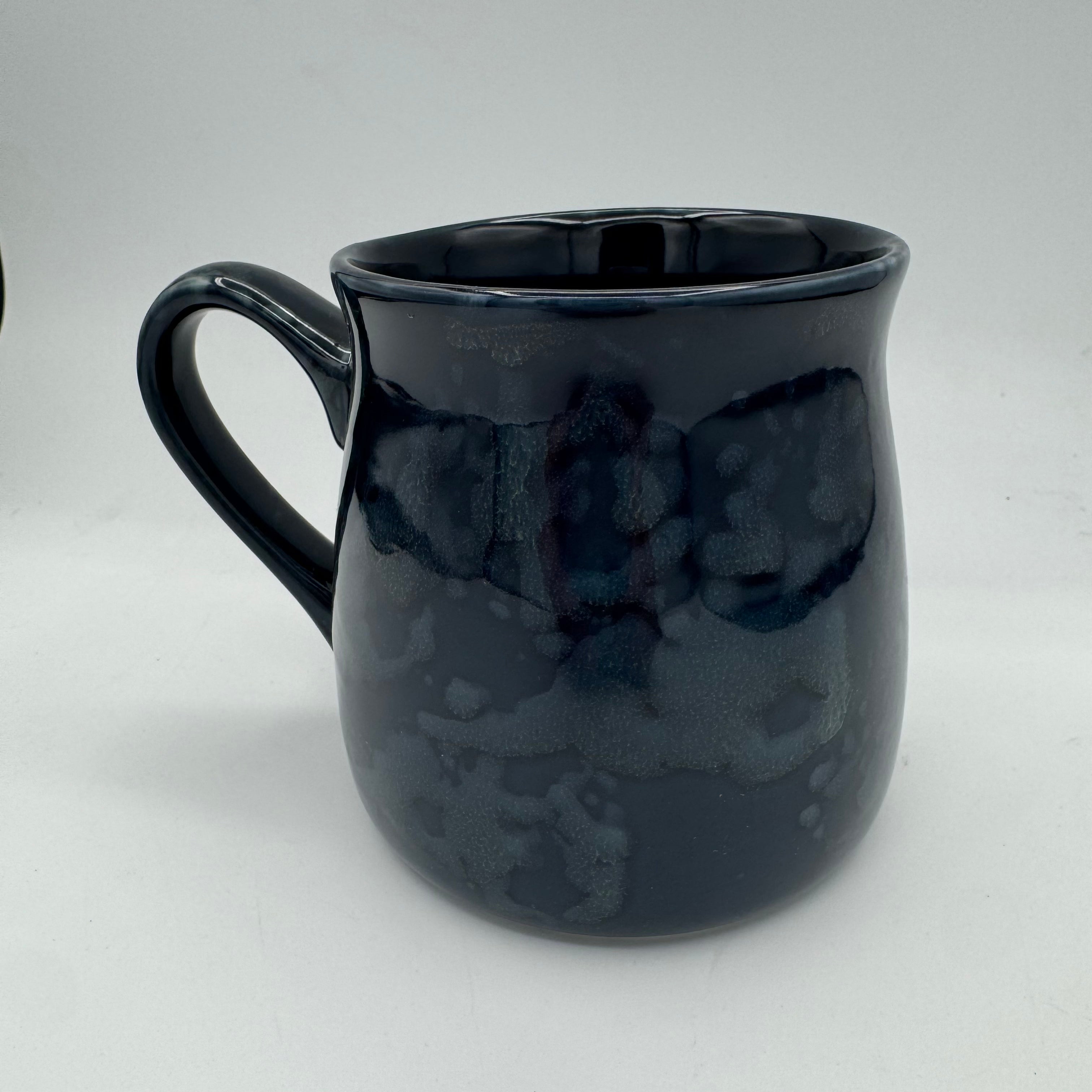 Black ceramic mug on a white background
