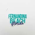 A die-cut sticker reading 'FERNANDINA BEACH florida' on a plain light gray background. The top and middle lines use a teal sans-serif font, while 'florida' is written below in dark navy script.