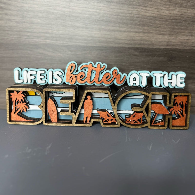 Decorative sign with 'Life is better at the beach' text on a wooden surface DIY Kit Fernandina Beach, Sip and Paint Workshops