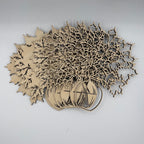 Laser-cut wooden autumn tree and pumpkin craft kit on a light gray background.