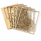 Set of wooden laser-cut decorative panels on a white background