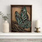 Decorative wall art with a leaf design in a wooden frame on a shelf.