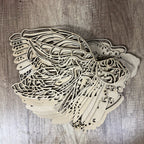 Stack of decorative wooden angel wings on a wooden surface