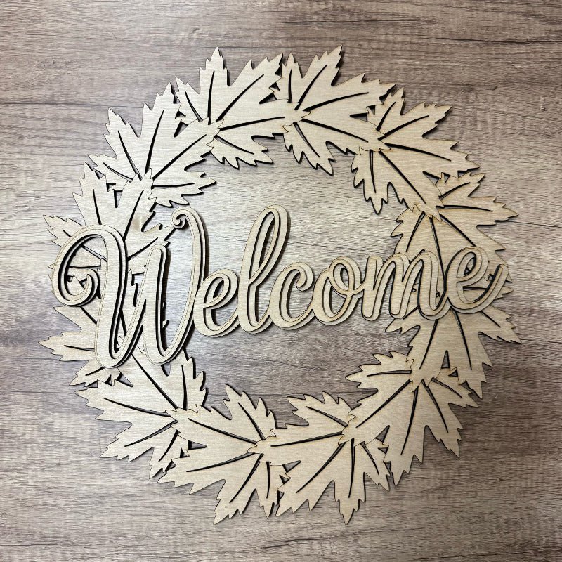 Wooden wreath with 'Welcome' text on a wooden background