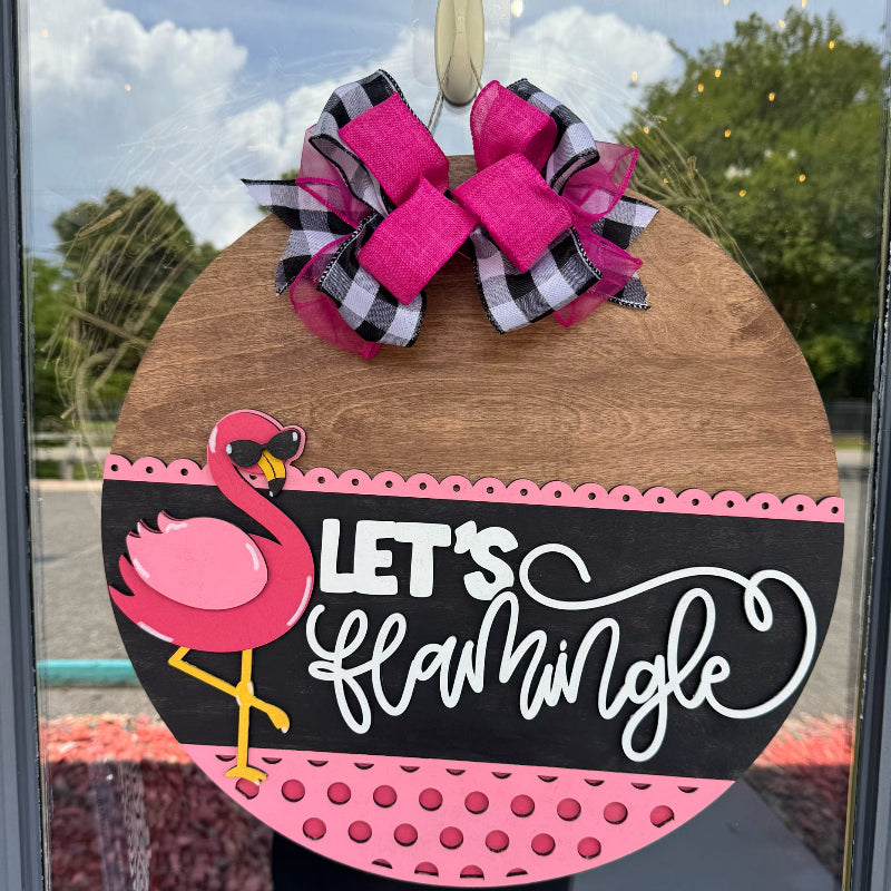 Decorative door hanger with flamingo design and 'Let's Flamingle' text, featuring a large pink bow.
