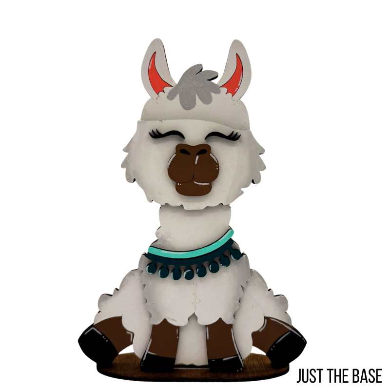 wood figure of a llama with a white face, brown body, and gray horns on a white background.