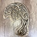 Wooden decorative item shaped like a peacock on a wooden surface