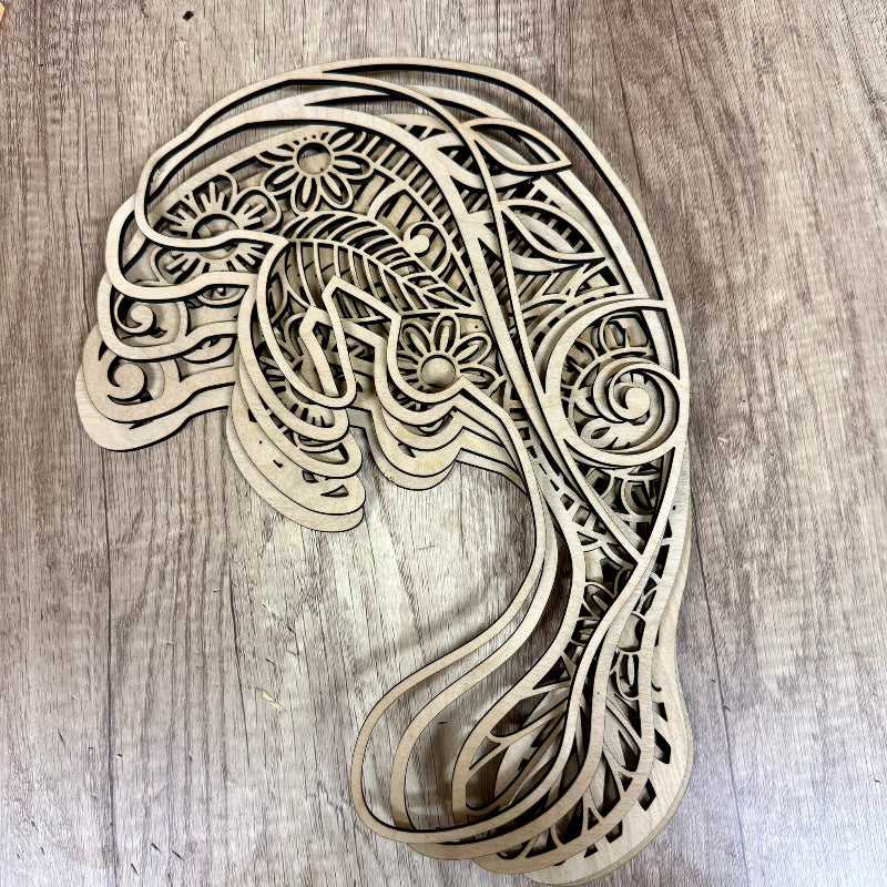 Wooden decorative item shaped like a peacock on a wooden surface