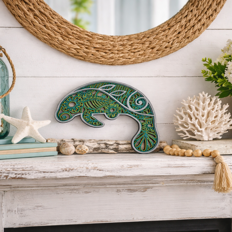 Decorative mantel with a green dolphin sculpture, starfish, and coral on a white surface.