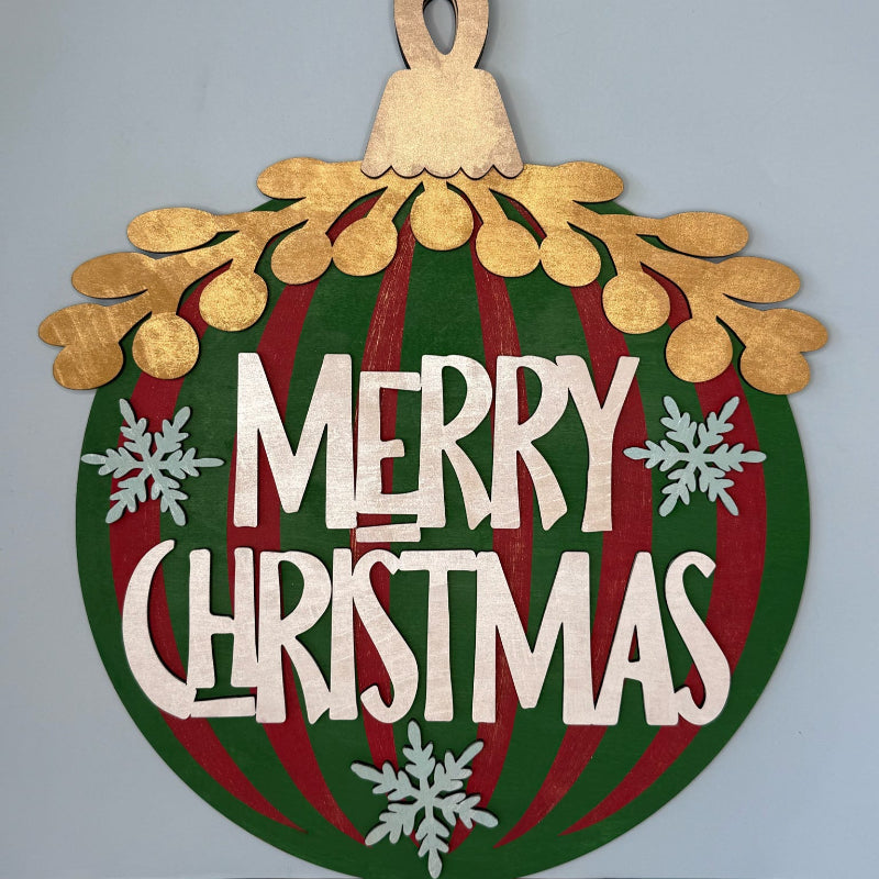 Decorative Christmas ornament with 'Merry Christmas' text on a plain background