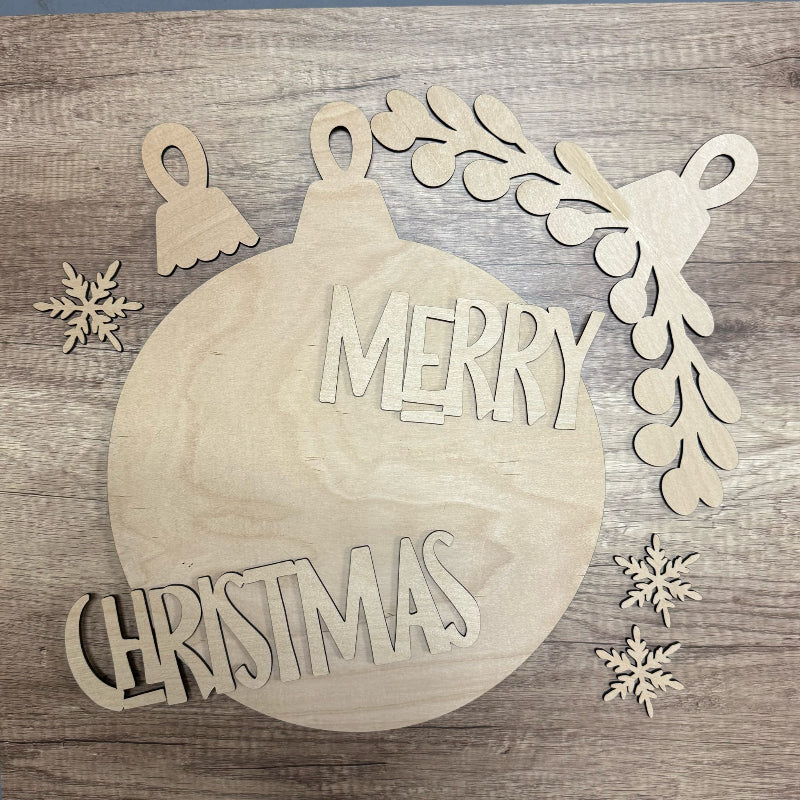 Wooden Christmas ornament with 'Merry Christmas' text on a wooden background