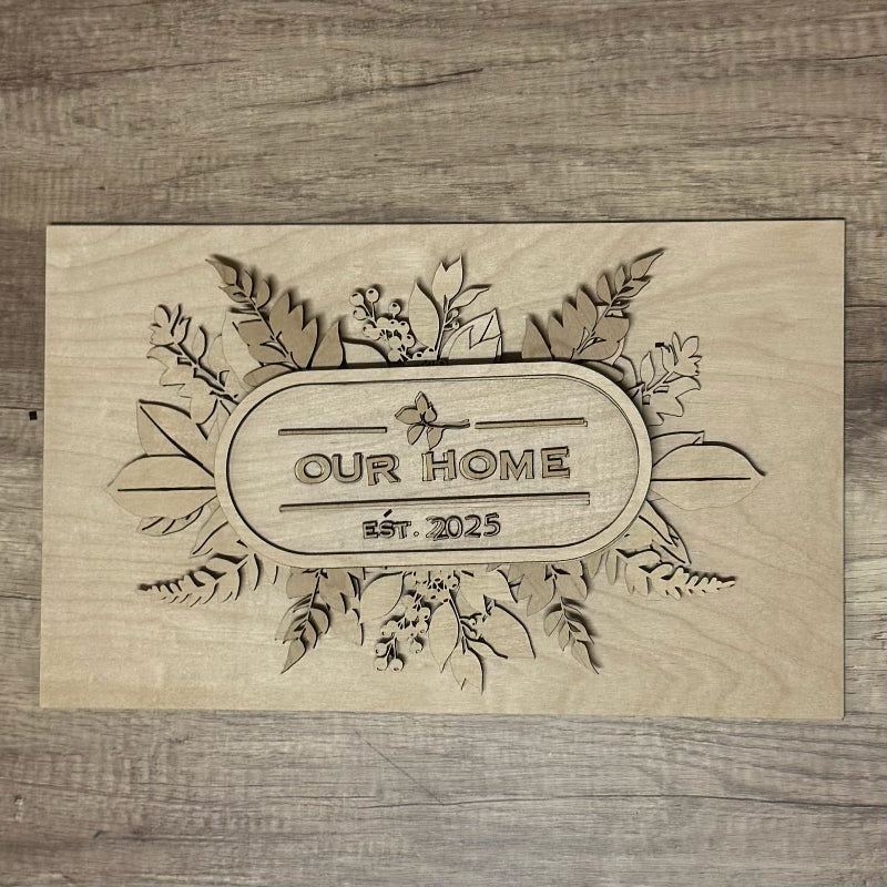 Wooden plaque with 'Our Home est. 2025' engraving on a wooden background