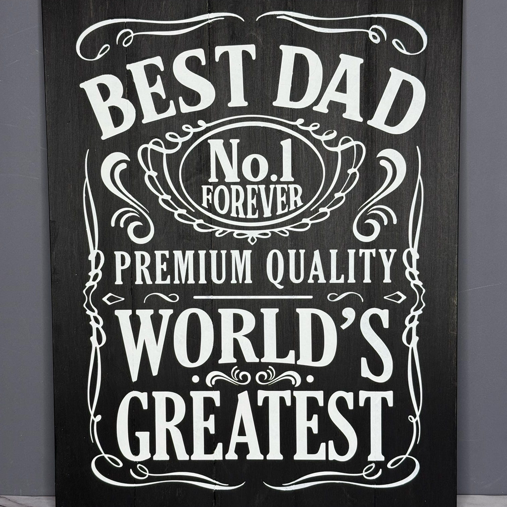 Decorative sign with text 'Best Dad No.1 Forever Premium Quality World's Greatest' on a dark background