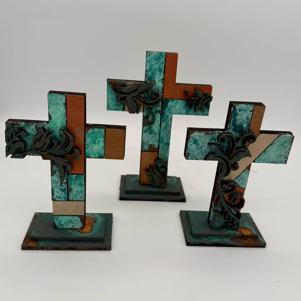 Three decorative crosses with intricate designs on a white background