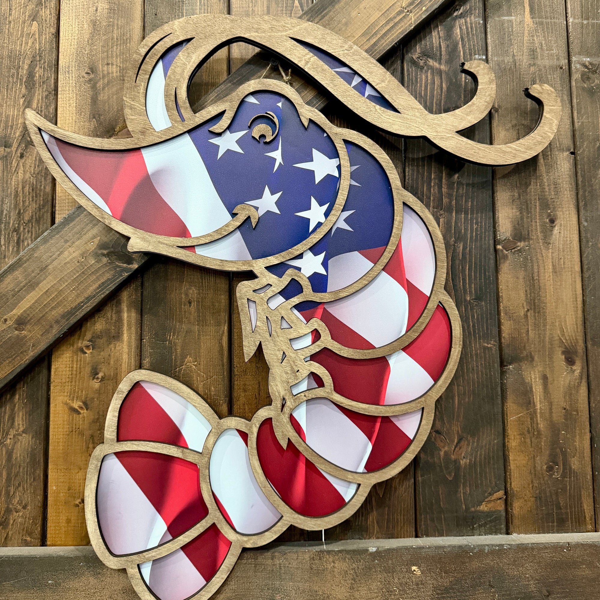 Shrimp Door Hanger  with American flag design on a wooden background