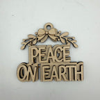A laser-cut wooden ornament featuring the phrase 'PEACE ON EARTH' in raised letters beneath a bow and holly leaves, shown on a plain off-white background.