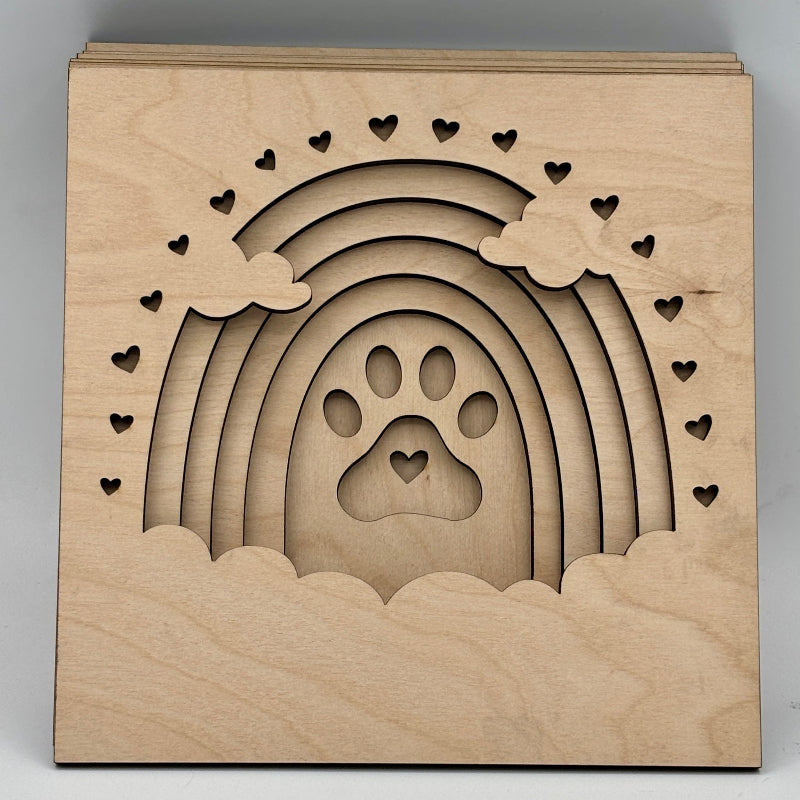 Wooden decorative item with a paw print and heart designs on a gray background