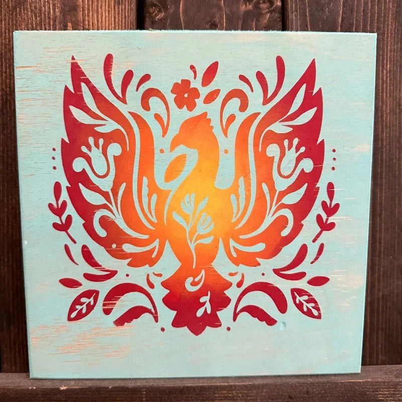 Decorative phoenix design on a wooden panel with a wooden background