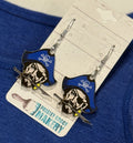 Pirate-themed earrings on a card with 'Paisley Grace Makery' branding against a blue fabric background.