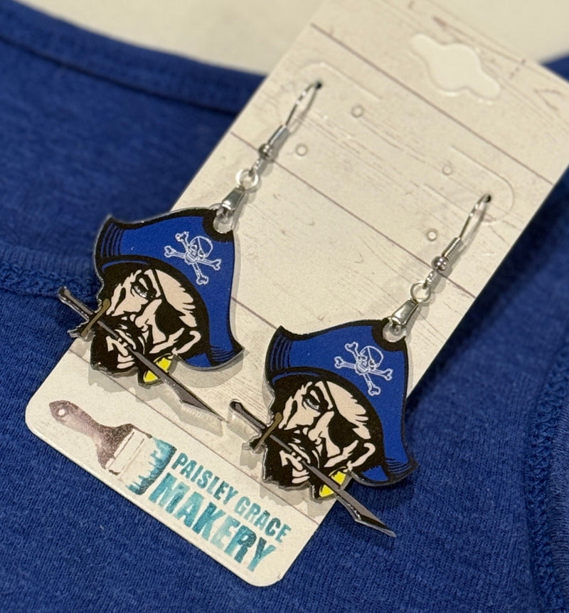 Pirate-themed earrings on a card with 'Paisley Grace Makery' branding against a blue fabric background.