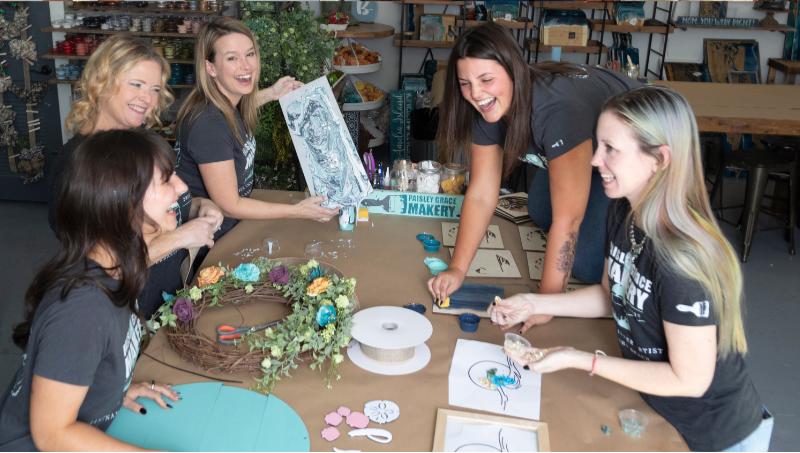 Collage of people holding decorative signs and engaging in craft activities.