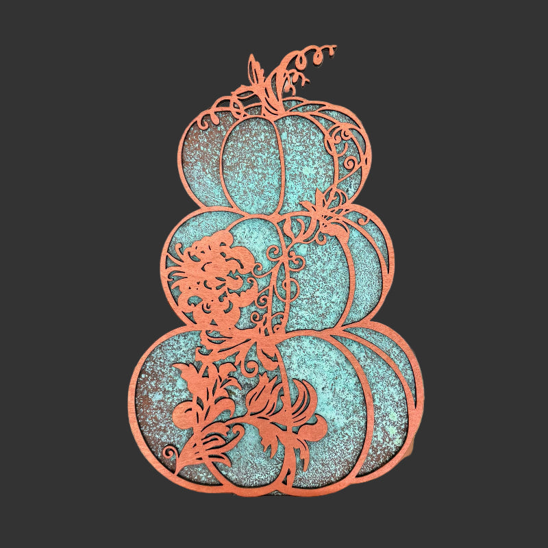 Decorative three-tiered wooden sculpture with intricate carvings held in a store setting.