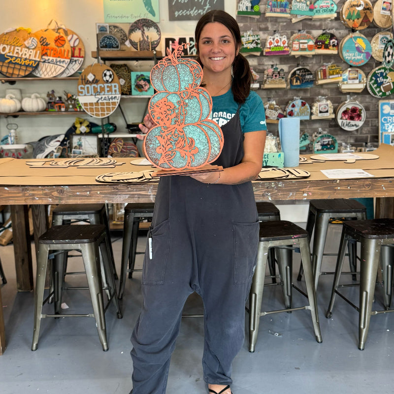 Person holding a decorative item in a craft store setting