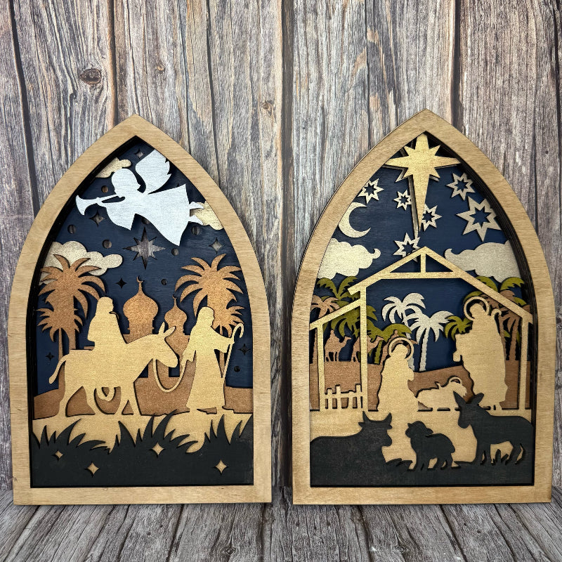 Two wooden nativity scene wall hangings on a wooden background